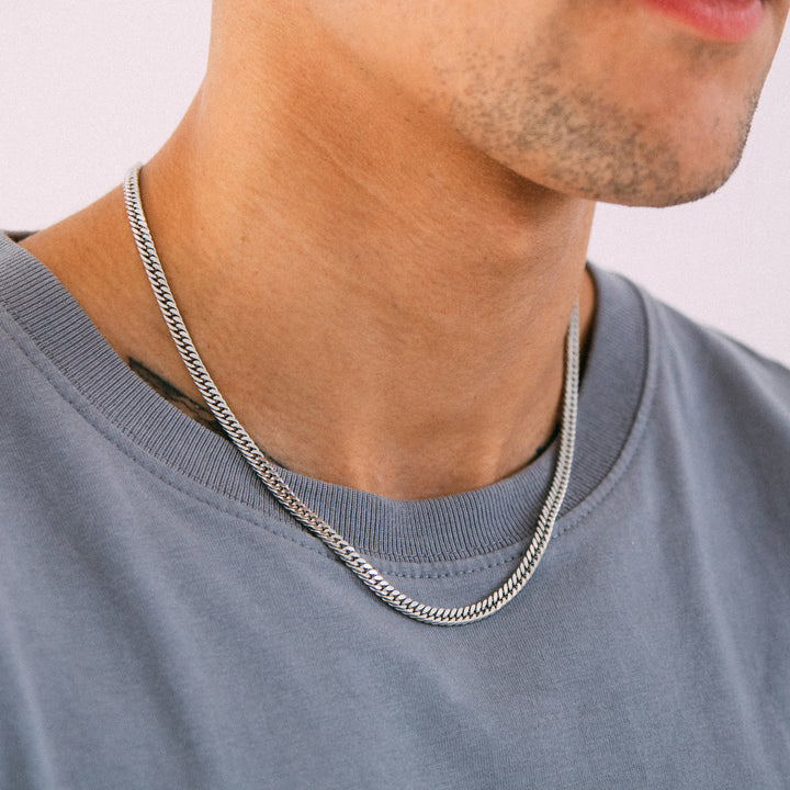 Model wearing mens 4.5mm silver tight curb chain necklace