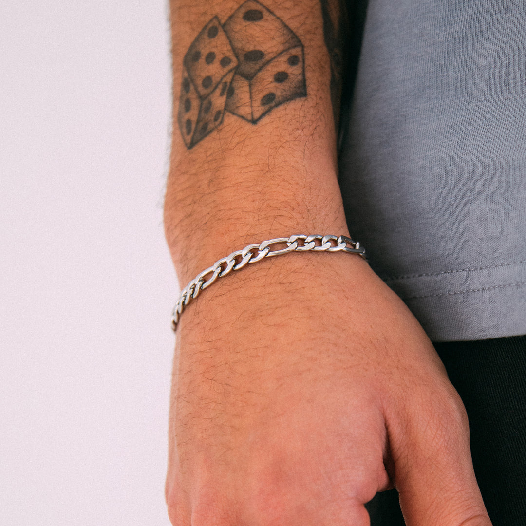 Model wearing mens 5mm silver figaro chain bracelet